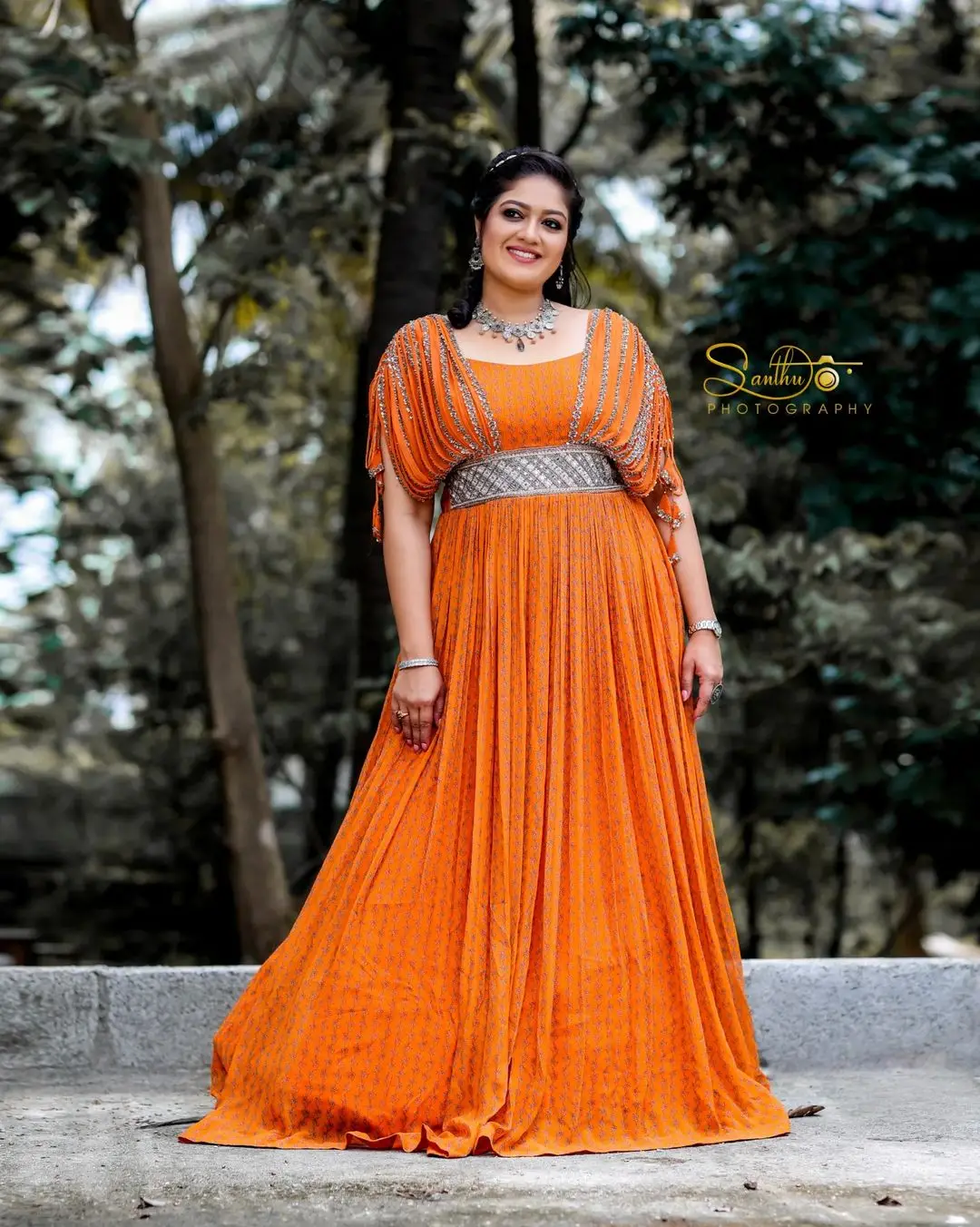 Meghana Raj Wearing Beautiful Earring Jewellery Orange Gown